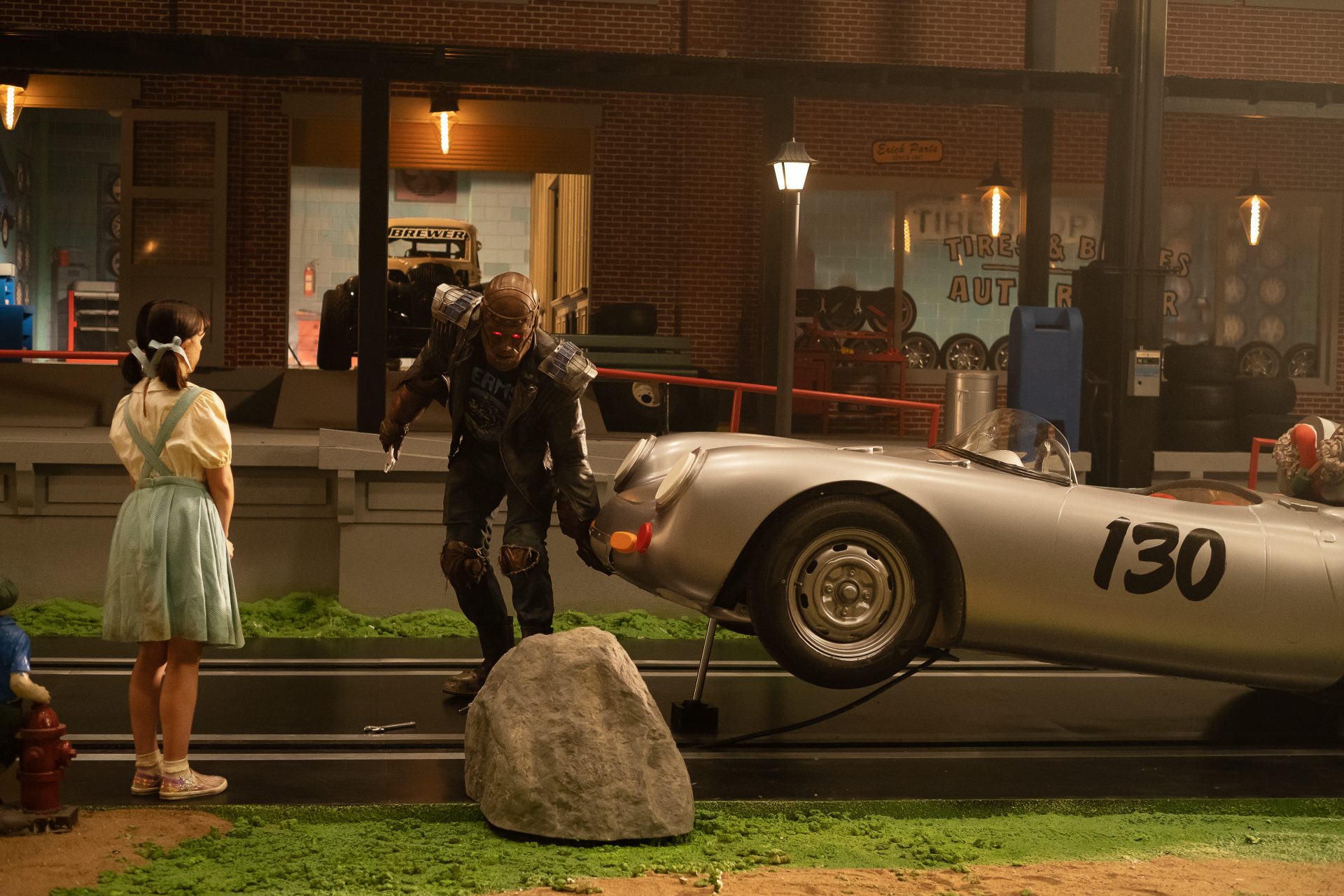 Doom Patrol Season 2 E1 - Robotman picking up a car in front of Dorothy